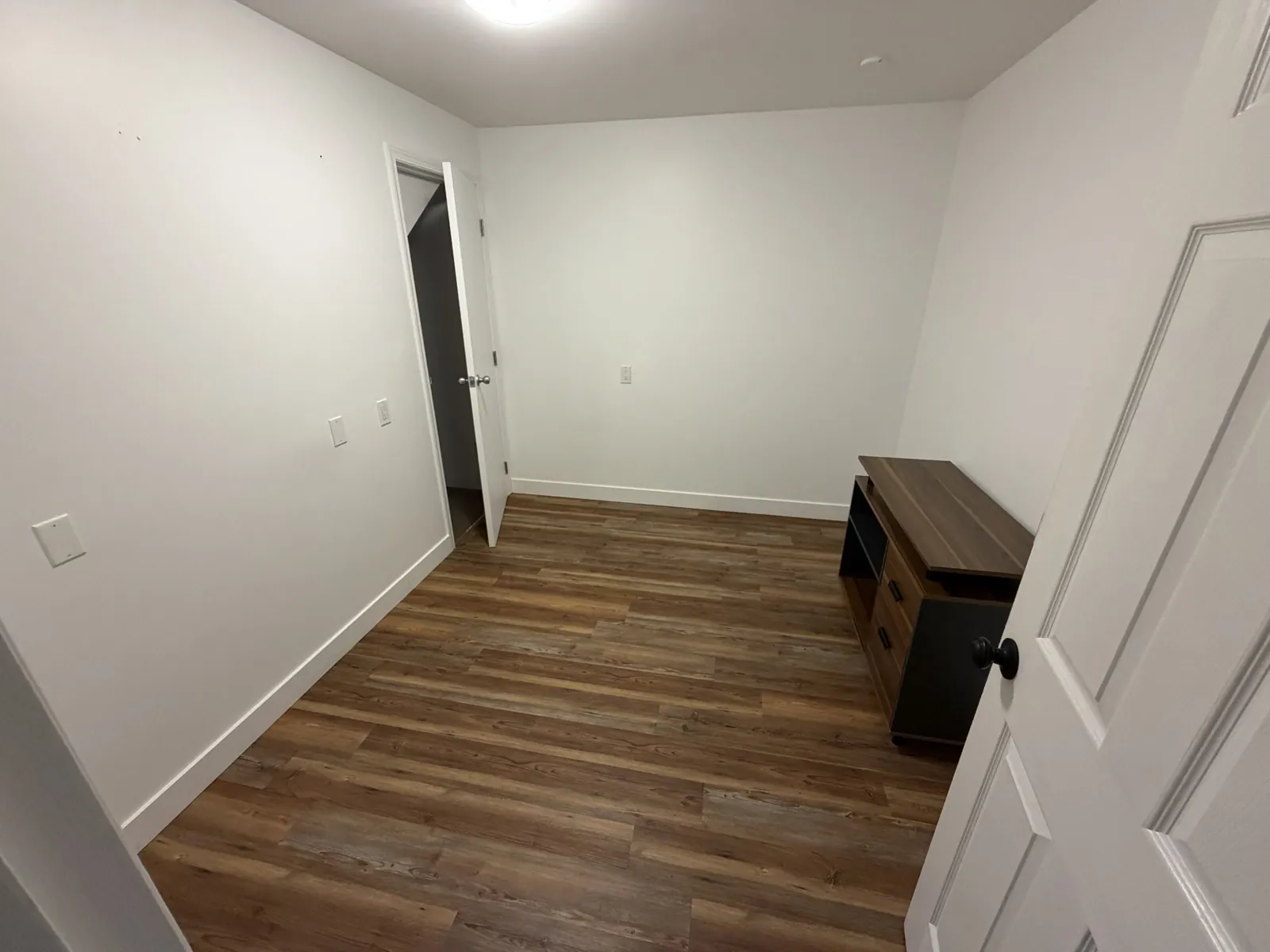Room 3: empty room with wood-look floor, white walls and an open closet door
