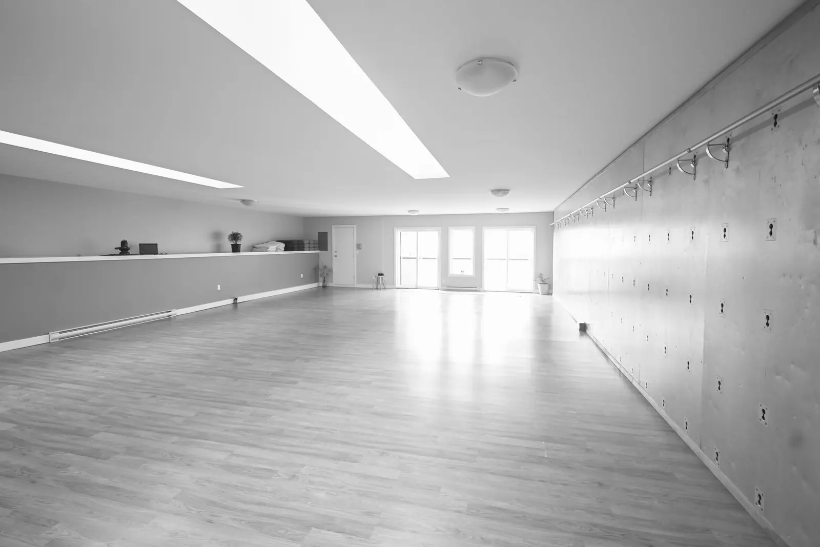 The yoga studio: bright open room with skylights, wood floor and rope wall