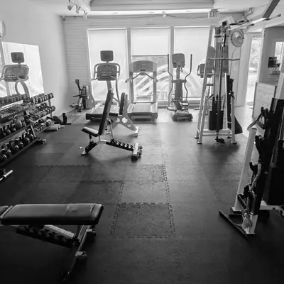 Open training floor with benches and cable machine