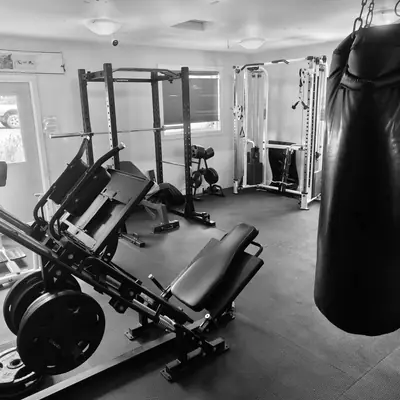 Strength room with power rack and leg press